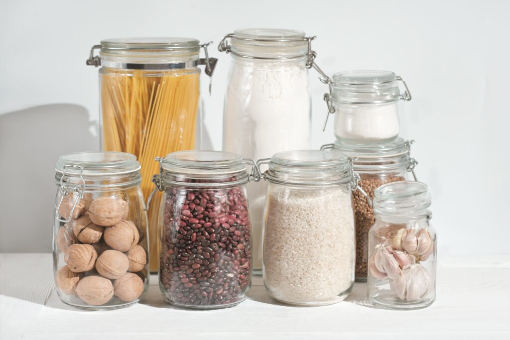 glass jars with grains and pasta nuts and sugar o