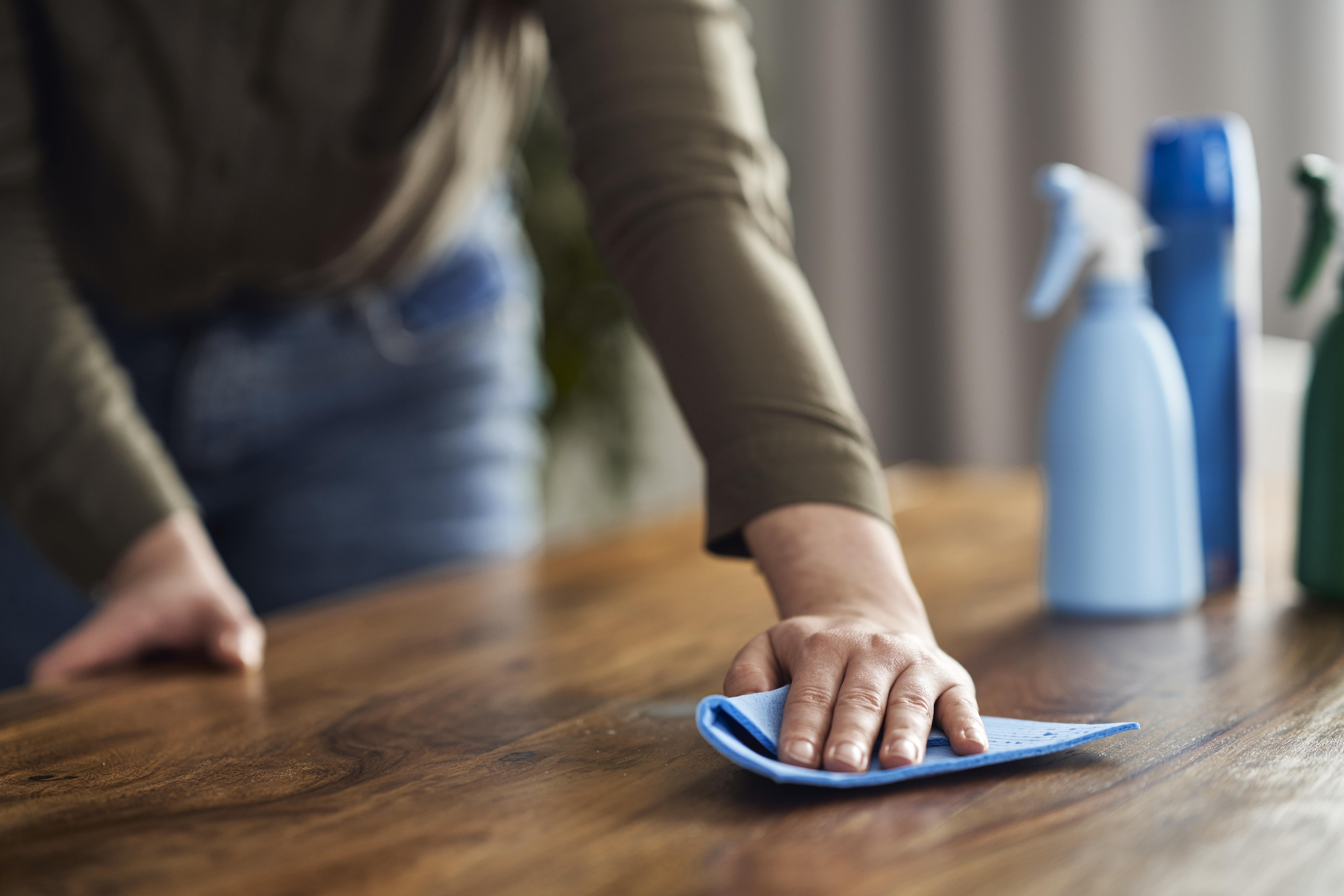 close-up-of-caucasian-woman-cleaning-table-at-home-min