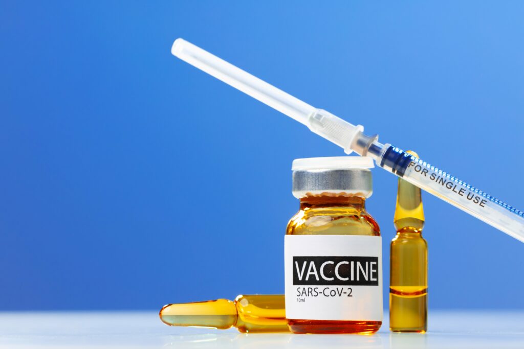 sars-cov-2-vaccine-vial-and-syringe-on-white-table-min