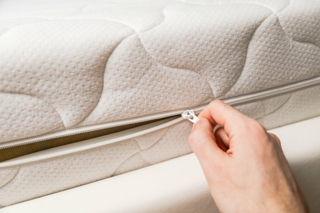 hand-opening-cover-of-new-mattress-with-zipper-ch-min
