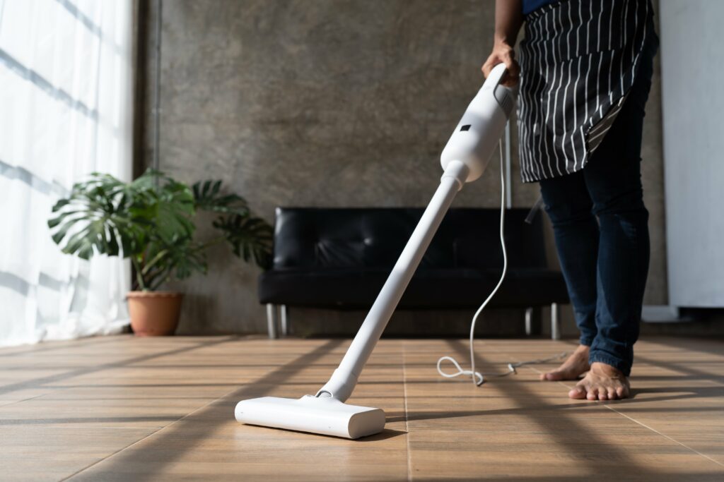 man-cleaning-home-with-vacuum-cleaner-min