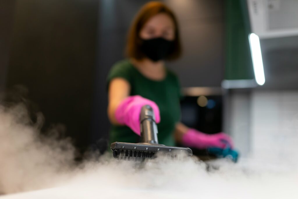woman-employee-cleaning-company-blows-vapor-out-of-min