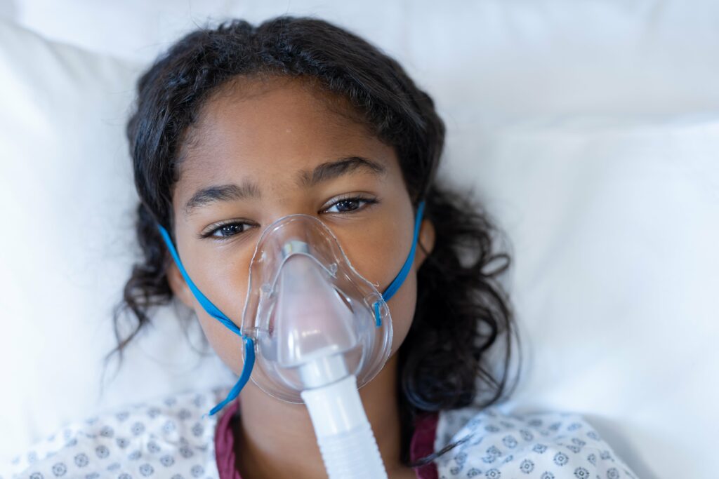 portrait-of-sick-mixed-race-girl-lying-in-hospital-min