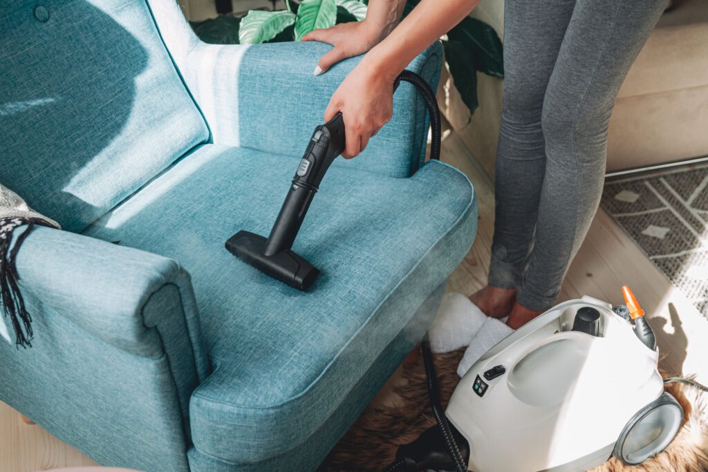hand  cleaning  a  armchair  with  steam  cleaner  home
