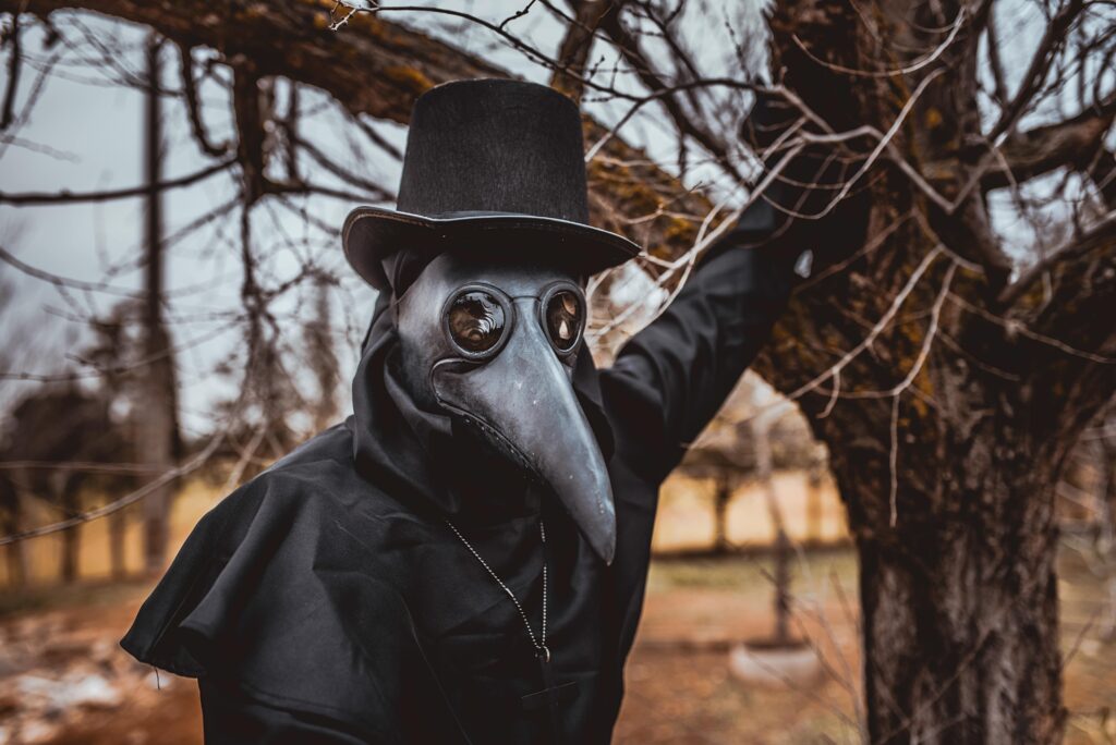 plague  doctor  with  a  cane  and  a  classic  dark  garb