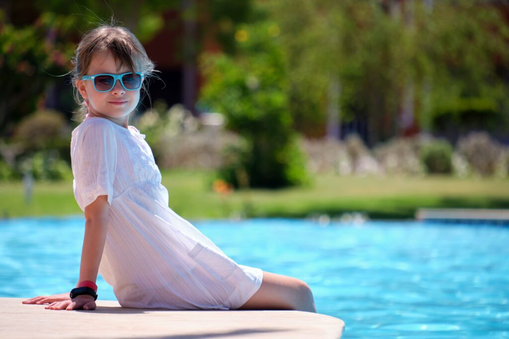 happy-child-girl-in-white-dress-relaxing-on-swimmi-utc-min